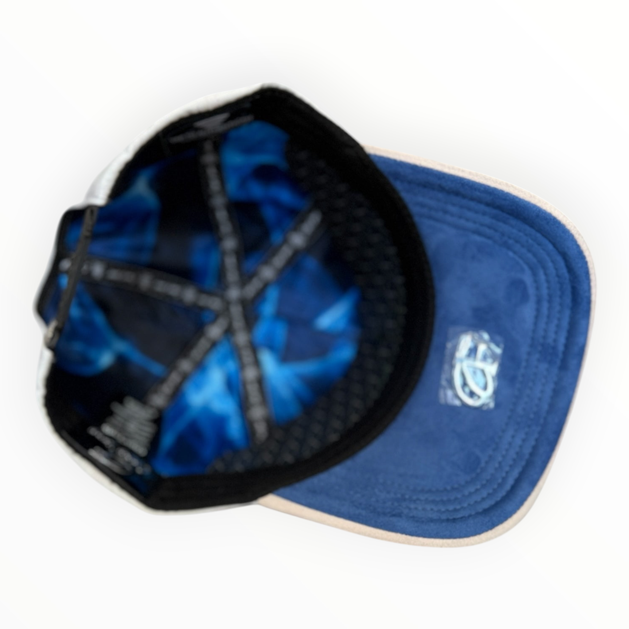 Hype Block baseball cap interior showing blue patterned lining and suede-feel brim on a white surface