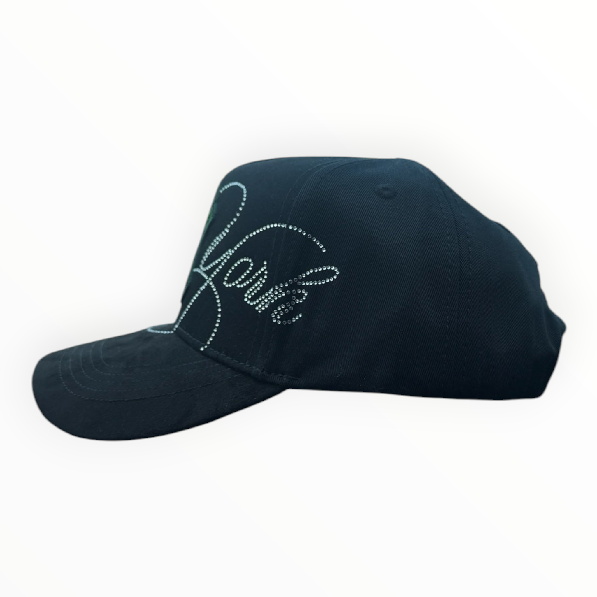 Hype Block black baseball cap with rhinestone New York script lettering, displayed on a car dashboard.