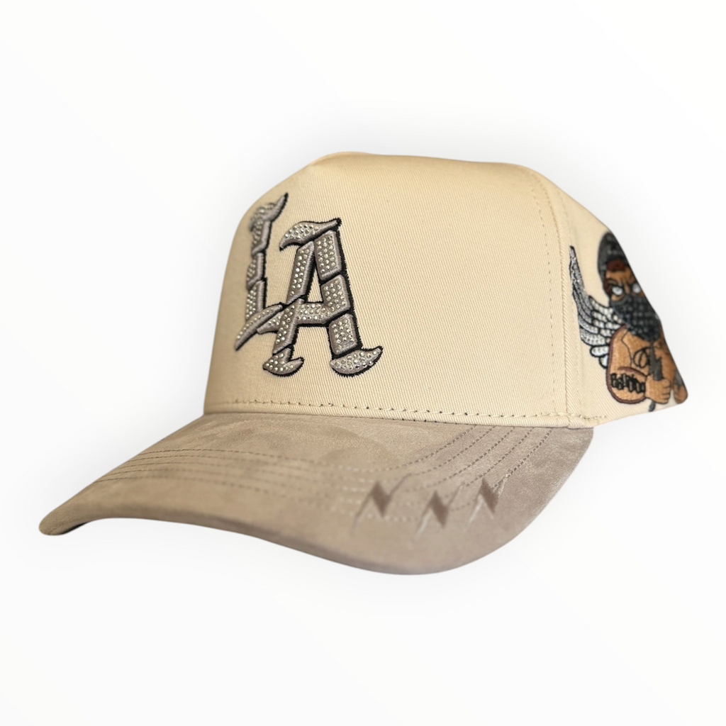 Hype Block cream and taupe snapback cap with rhinestone LA logo and Bad Angel side embroidery on a suede-feel brim.