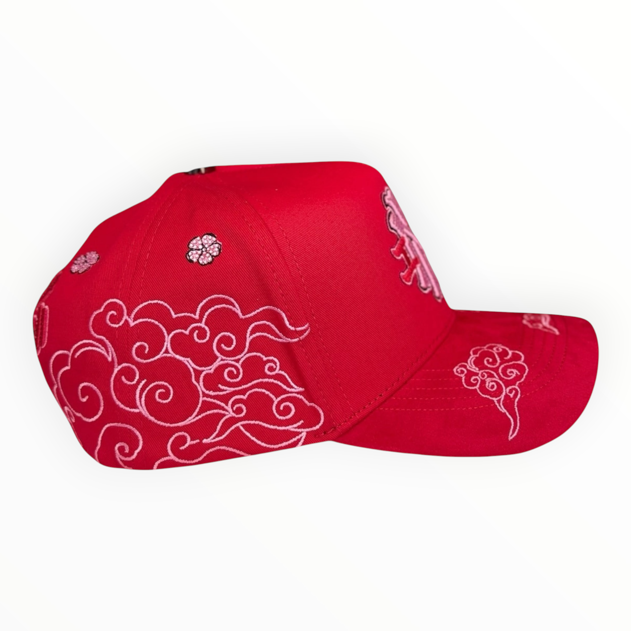 Hype Block red baseball cap featuring white embroidered cloud patterns and cherry blossom details on the side.