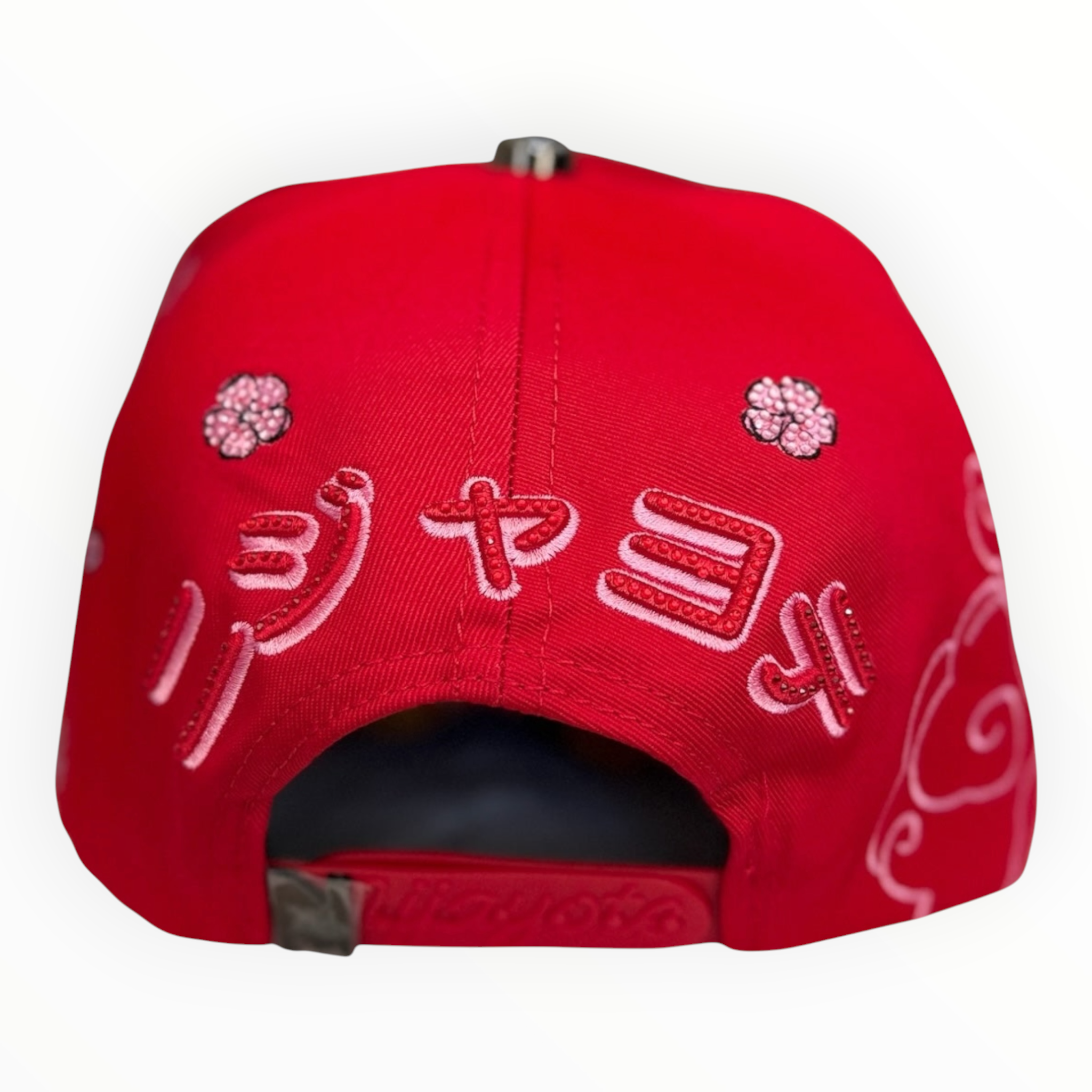 Hype Block red baseball cap featuring detailed pink cherry blossom and white cloud embroidery on the back strap area.