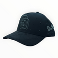 Hype Block black San Diego Padres snapback cap with rhinestone SD logo and stud embellishments on a car dashboard